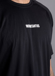 Close-up of ONCOURTANTICS black performance t-shirt fabric and small chest logo detail, highlighting lightweight, breathable material.