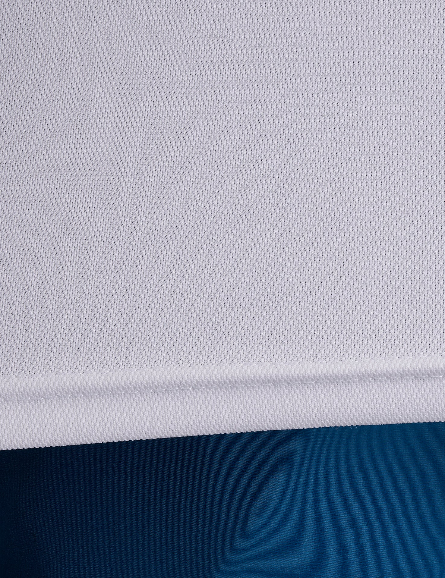 Close-up of ONCOURTANTICS white performance t-shirt fabric, highlighting lightweight, breathable material.