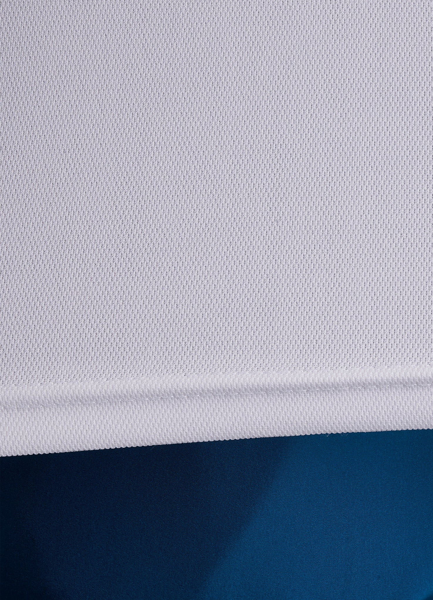 Close-up of ONCOURTANTICS white performance t-shirt fabric, highlighting lightweight, breathable material.